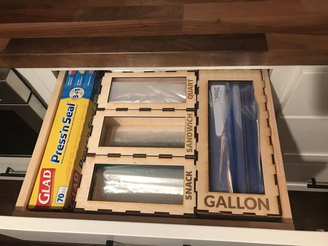 open kitchen drawer with sections for different sized plastic bags