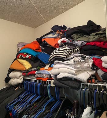 before image of reviewer's closet shelf with clothes in a messy stack