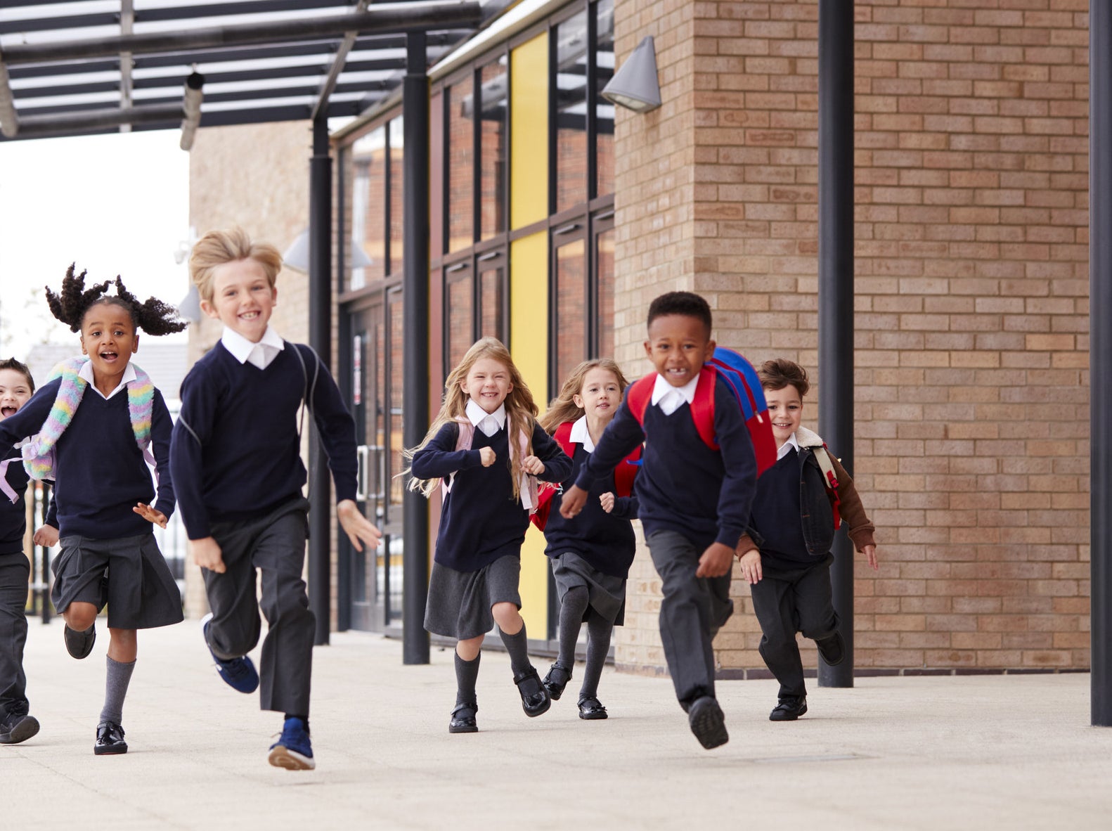 Schoolkids run out of the school after the final bell rang