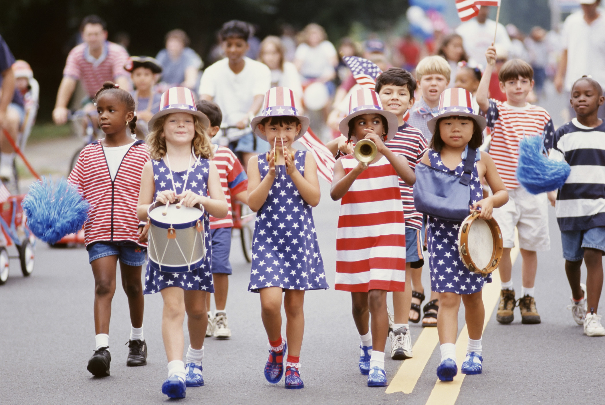 American kids walk in a fourth of july parade