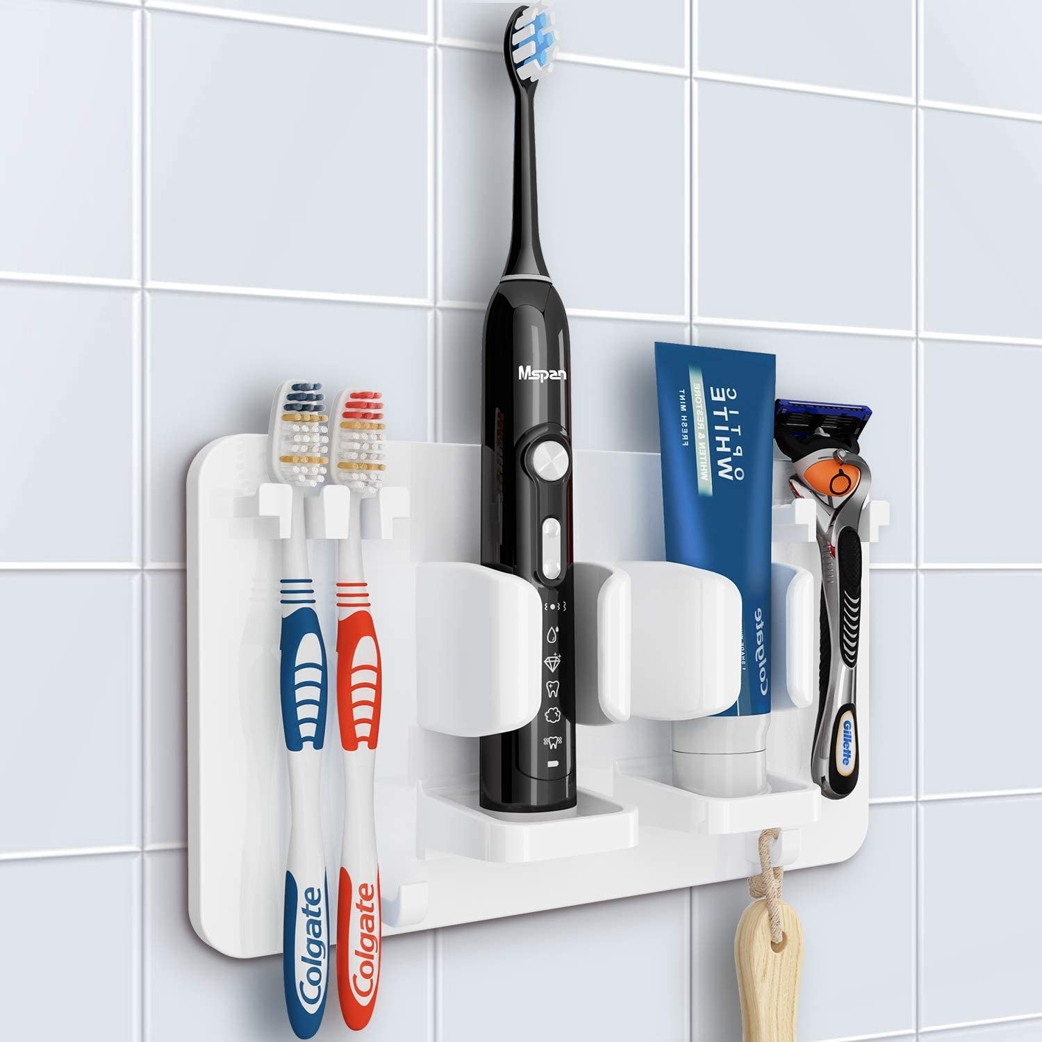 Several bathroom accessories in the toothbrush station