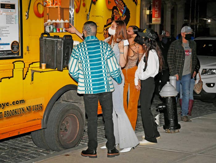 Gigi, Bella, and Zayn standing in front of the food truck in New York City