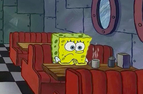 SpongeBob sitting alone in a diner booth drinking coffee