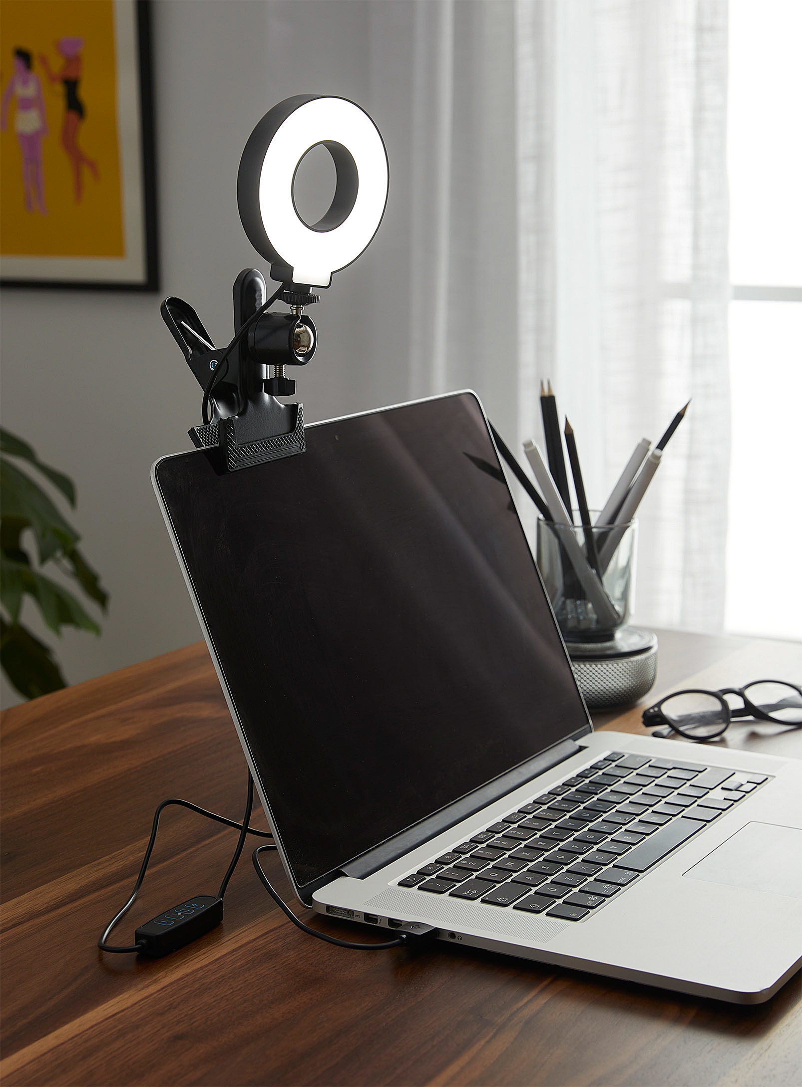 A petite ring light attached to the top of a laptop