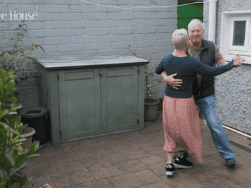 An elderly couple from the reality tv show &quot;Goodbye House&quot; dancing in their backyard