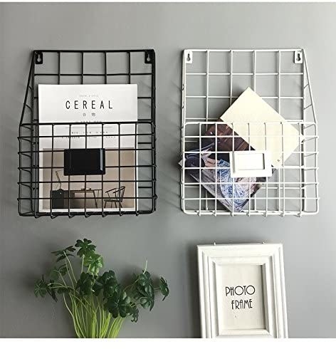 Two wall-mounted magazine racks with books inside 