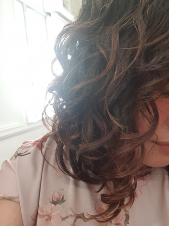 Reviewer with loose curls after using the cream