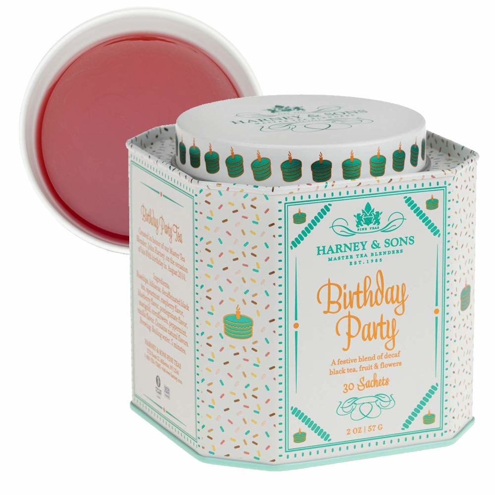The tea tin with the words &quot;birthday party&quot; printed on the front
