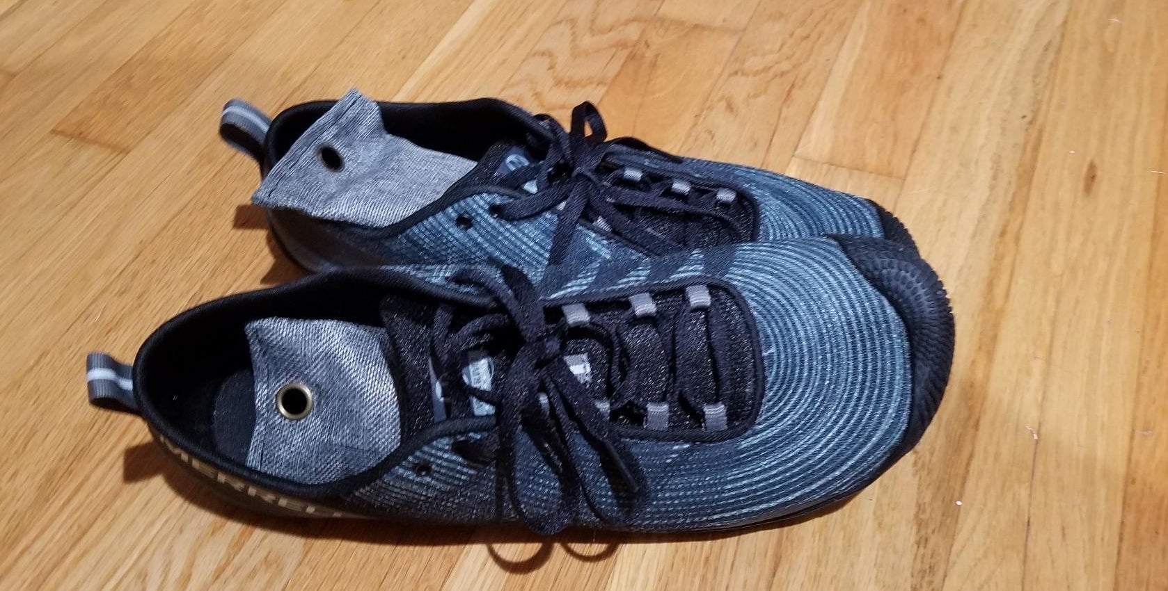 a reviewer photo of a pair of sneakers with dark blue shoe deodorizers inside 