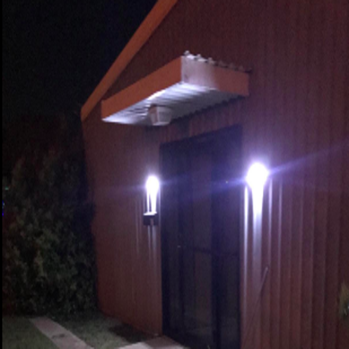 Two lights on either side of a garage door 