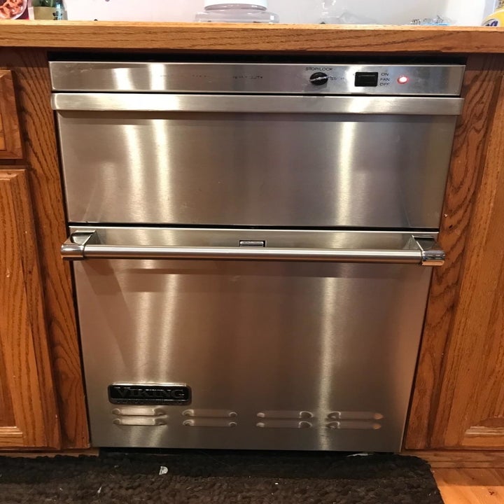 a reviewer photo of the same dishwasher looking shiny and clean 