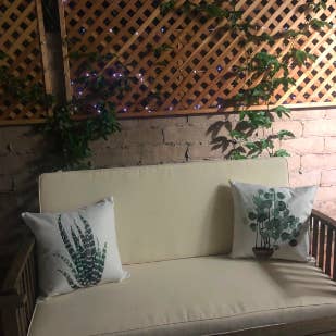 Reviewer's outdoor loveseat with two of the pillows