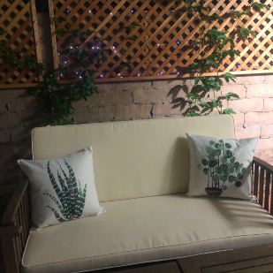 Reviewer's outdoor loveseat with two of the pillows