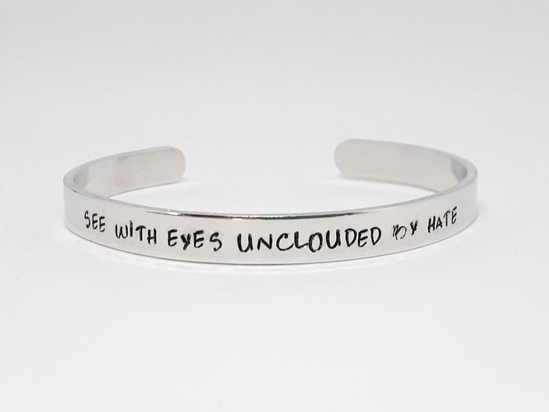 thin aluminum cuff with quote &quot;see with eyes unclouded by hate&quot;