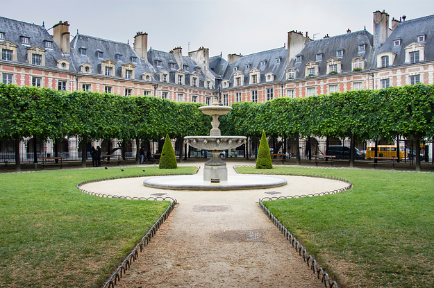 a palace with a courtyard with a big fountain in it