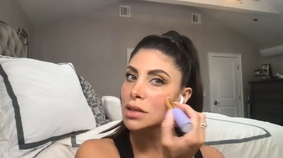 Image of Lauren prepping her skin