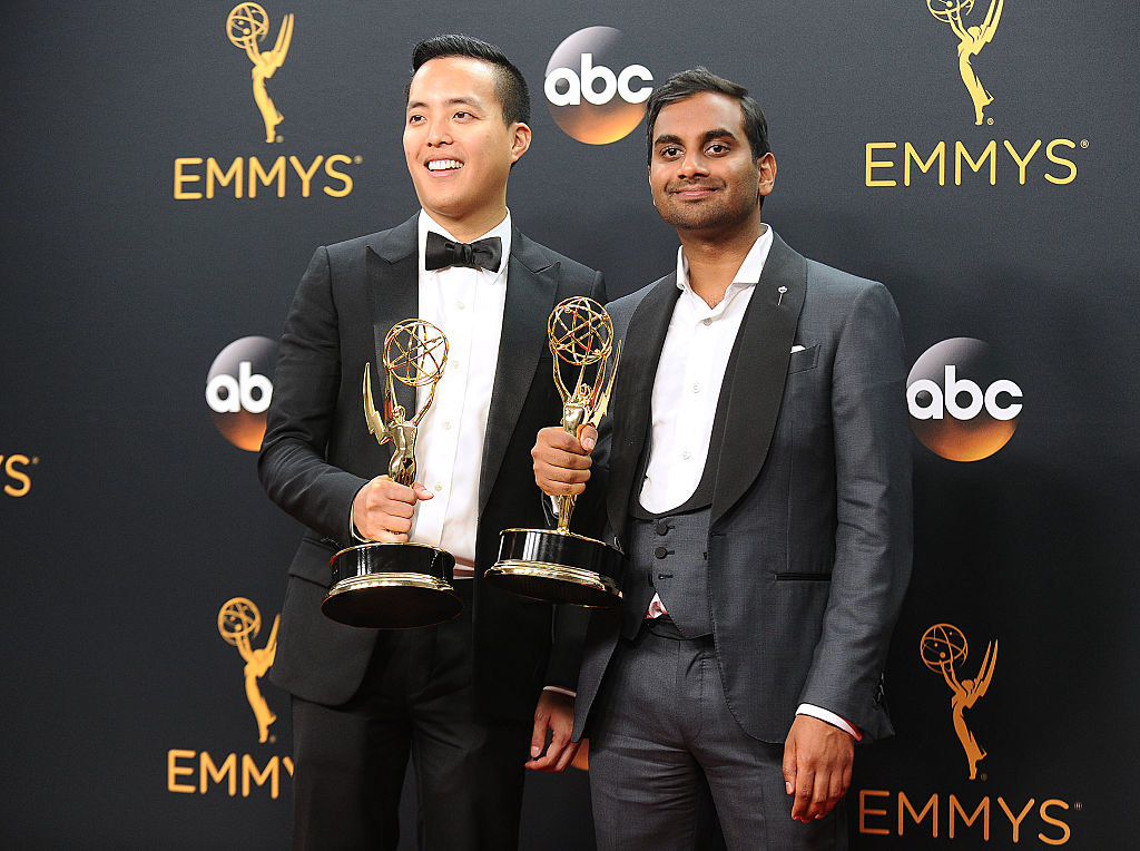 Alan Yang (L) and Aziz Ansari pose in the press room at the 68th annual Primetime Emmy Awards