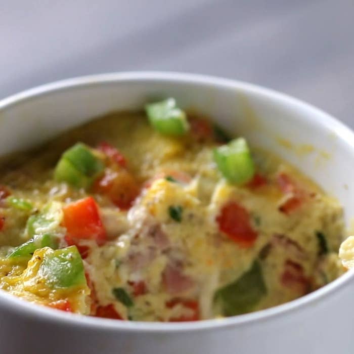 An omelet in a mug with veggies. 