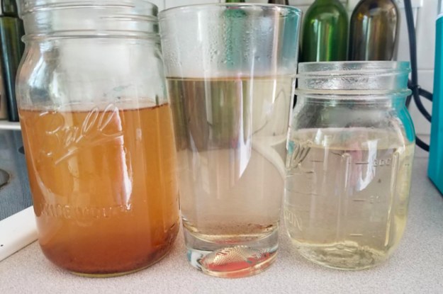 A customer review photo of the dirty water coming out of their Keurig after running the cleaning cup through it