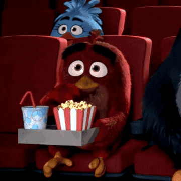 Red angry bird eating popcorn while at the movies