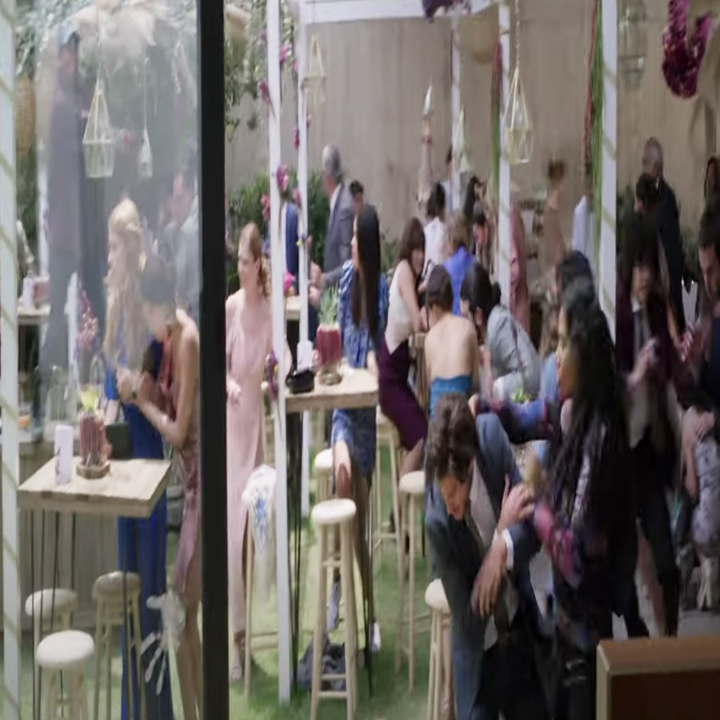 Screenshot of the movie new order, a group of family in distress looking to leave a hectic fight in their backyard
