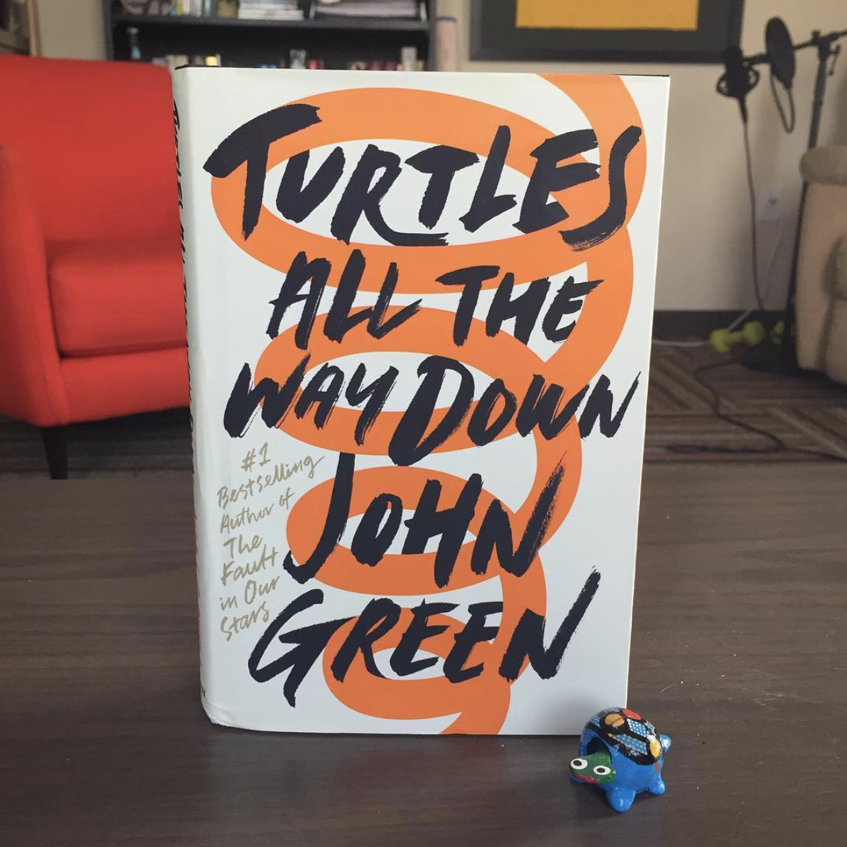 the book on a table with a small turtle figurine next to it