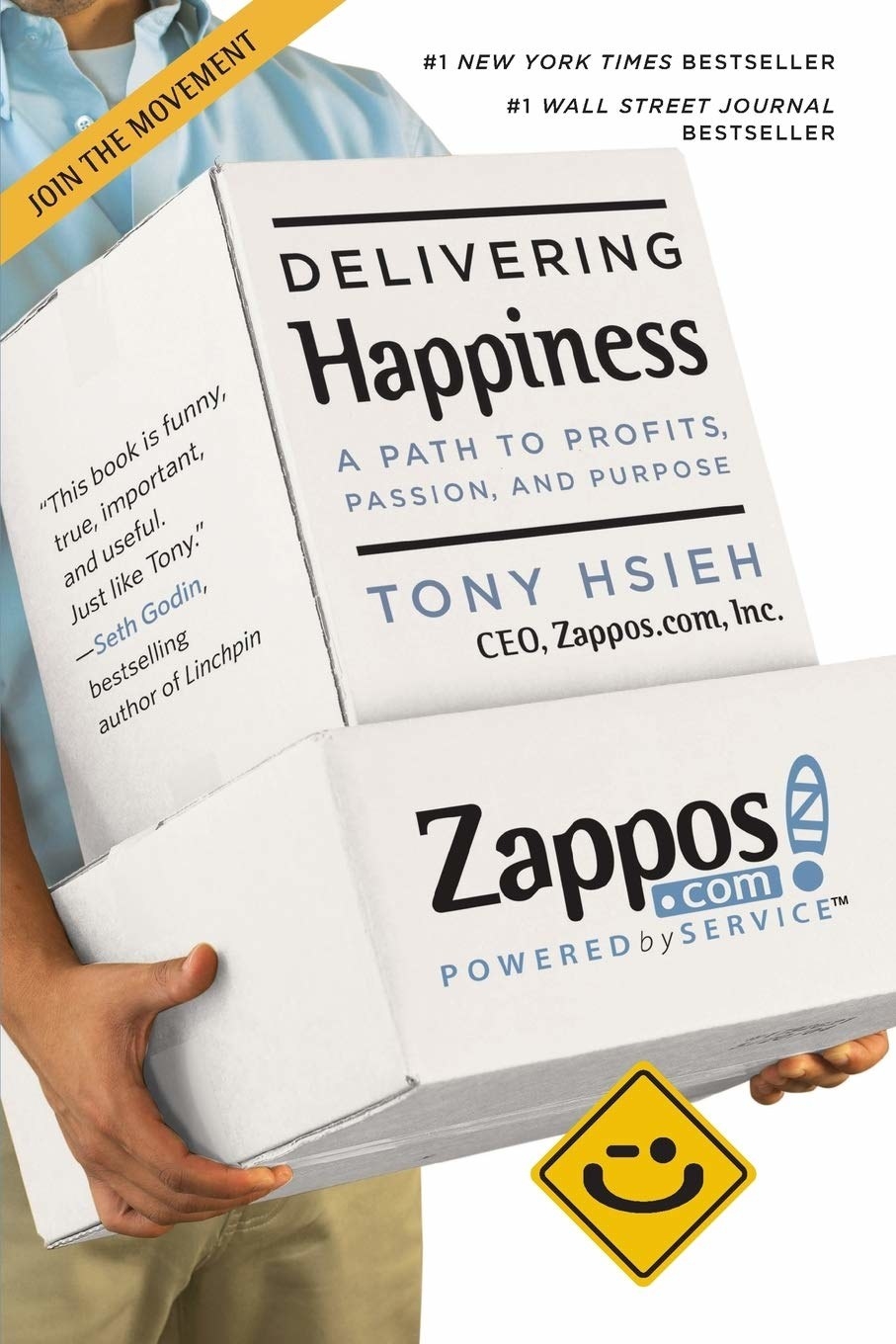 person holding a box that has the book details on it and the Zappos logo