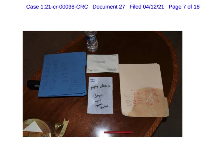 An image of illegible handwritten notes on a desk is seen in a court document
