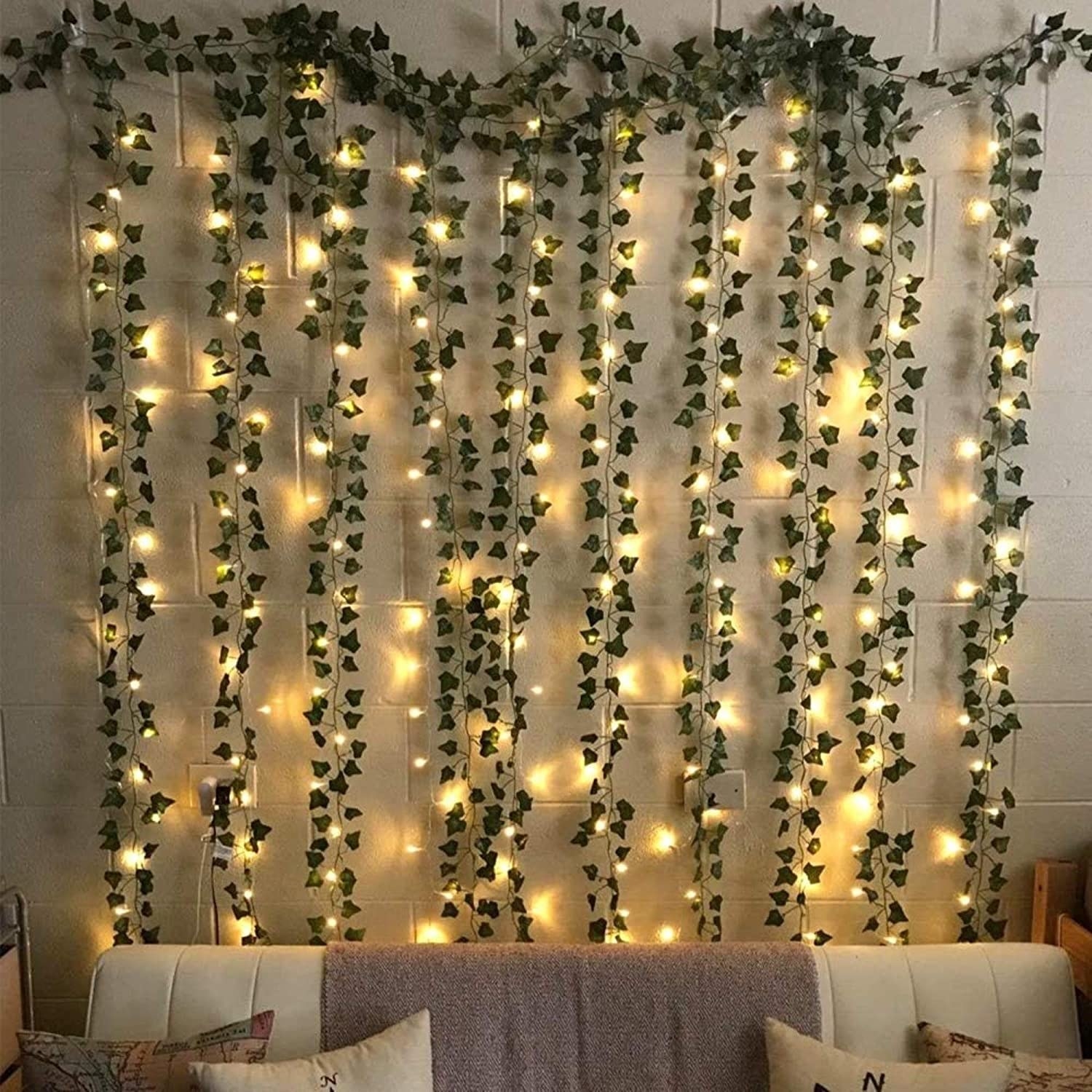 Garlands hanging from a wall, intertwined with lights.