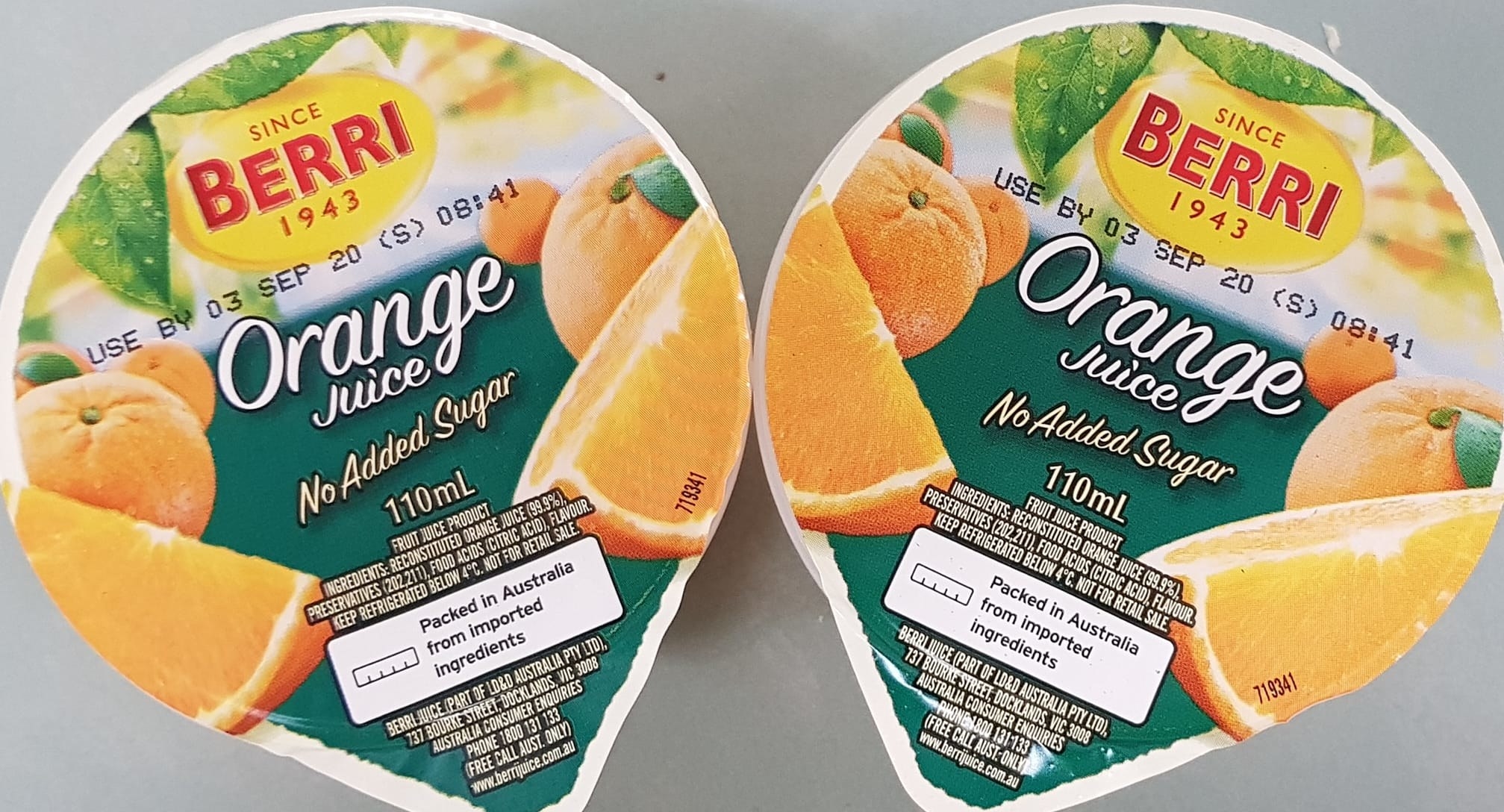 Two Berri brand orange juice cups 