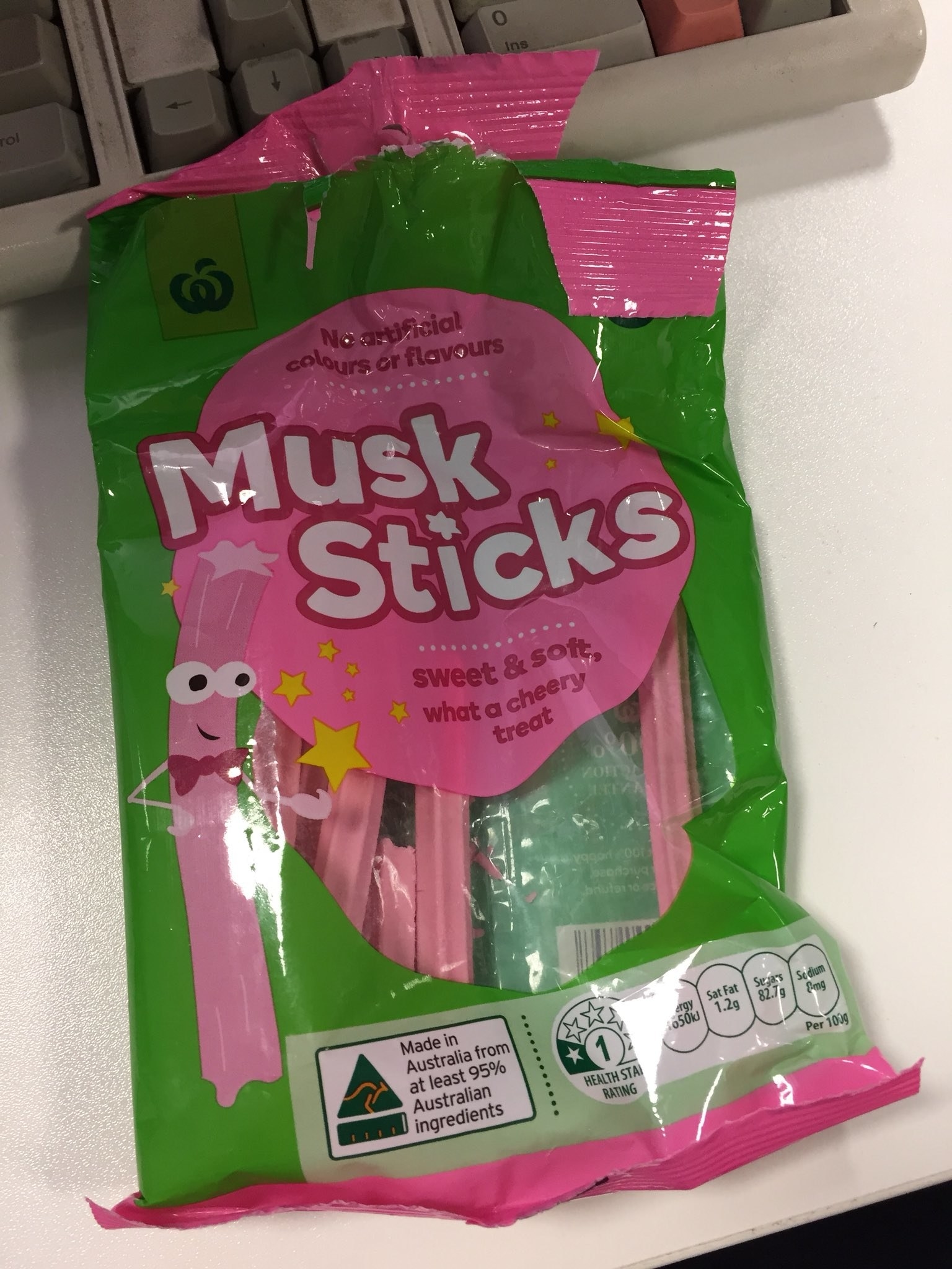 A half empty packet of Woolworths brand Musk Sticks on a table