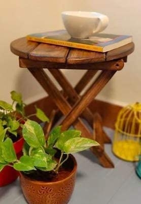 Table with a book and mug on it.