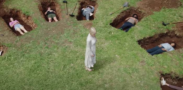 Nicole Kidman stands among a bunch of bodies lying in holes in Nine Perfect Strangers