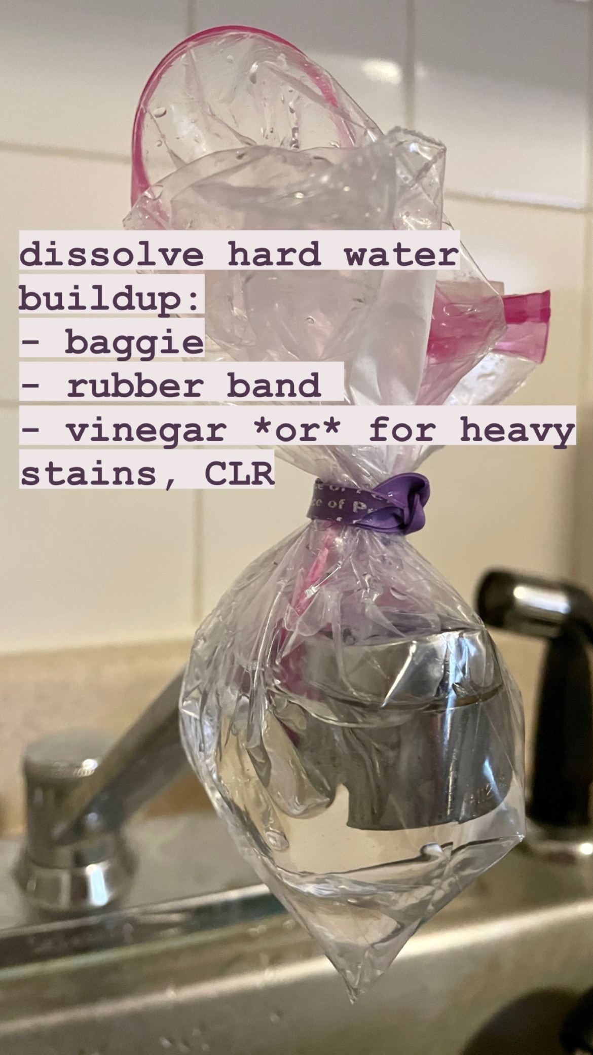 kitchen faucet with plastic bag filled with vinegar rubber-banded over the nozzle