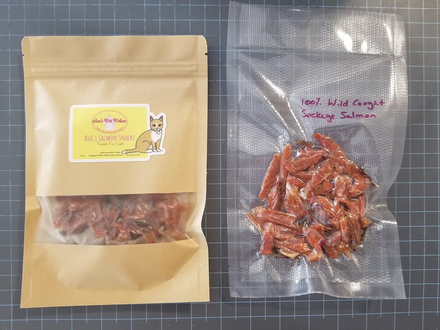 a bag of salmon cat treats next to a vacuum-sealed package of salmon treats