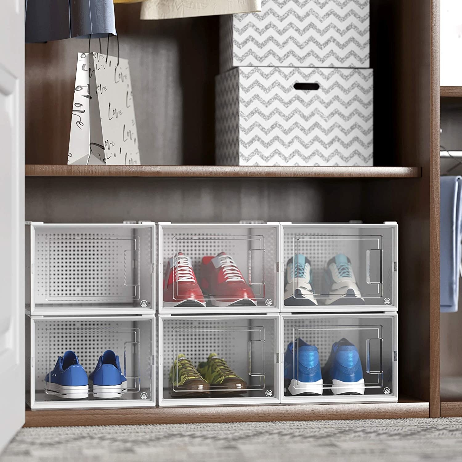 A set of six shoe containers stacked neatly in a closet 