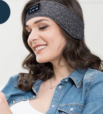 Model wearing wraparound grey fabric headband headphones 