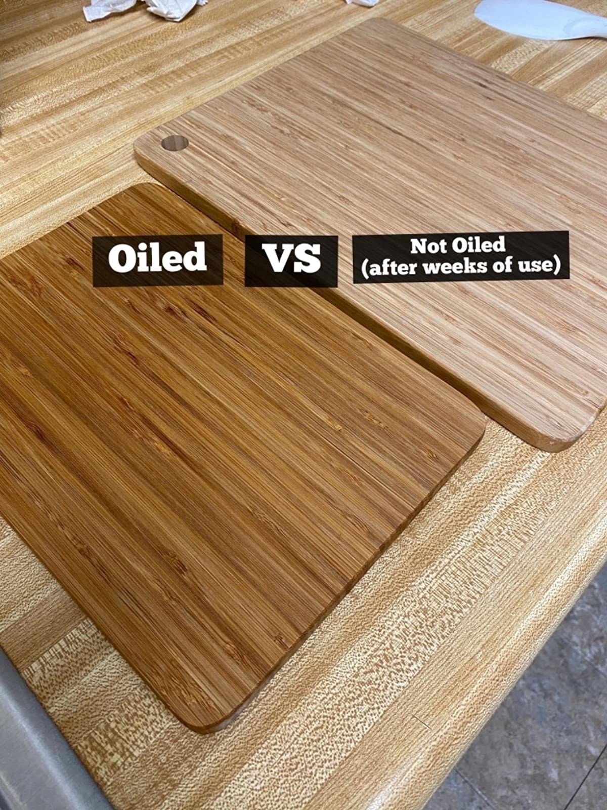 A customer review photo of two identical cutting boards side-by-side, one oiled, dark, and shiny, the other not oiled and pale