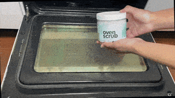 A gif of a person cleaning their over using the scrub