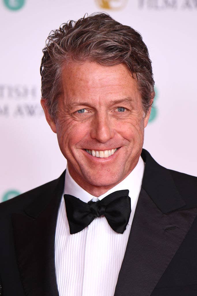 Hugh smiling and wearing a bow-tie