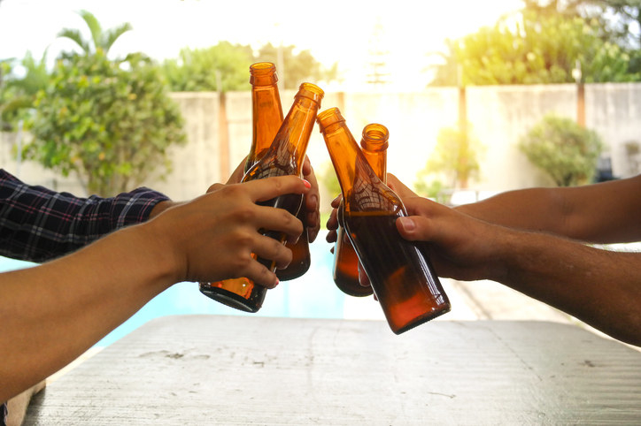 People toasting with beer cans