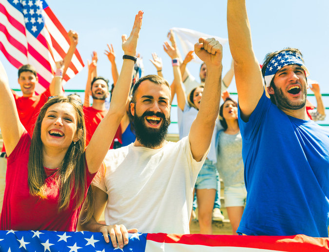 People, some waving the US flag, cheering