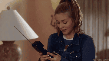 GIF of Cher from &quot;Clueless&quot; answering the phone excitedly