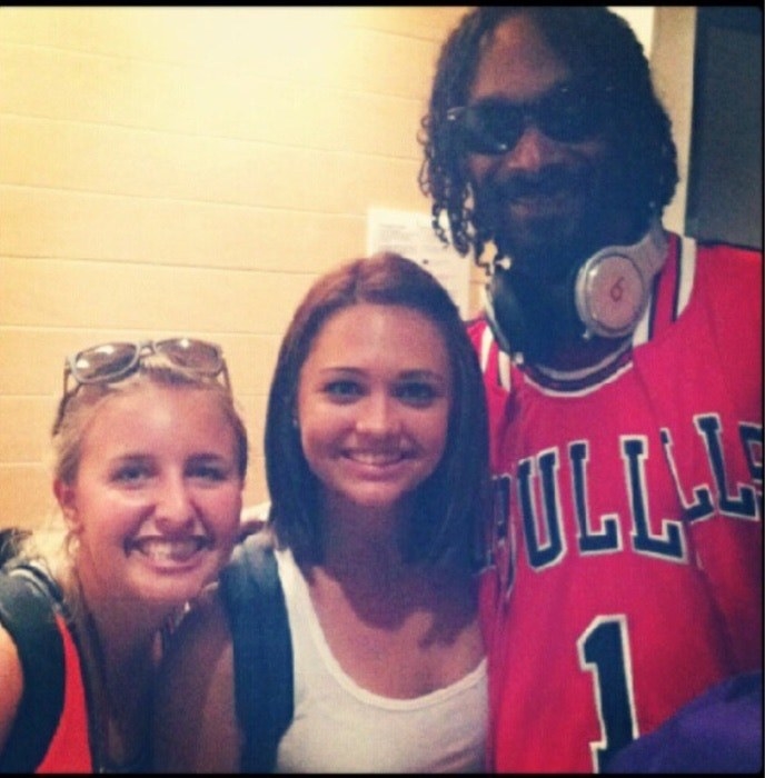 Snoop Dogg posing with two female fans outside of an elevator at LAX