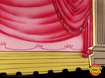 GIF of Duffy Duck bowing with in a tux and top hat on a stage