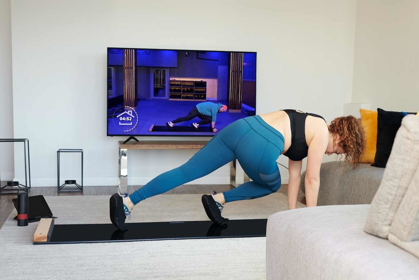 model performs a plank sliding movement on the Brrrn board