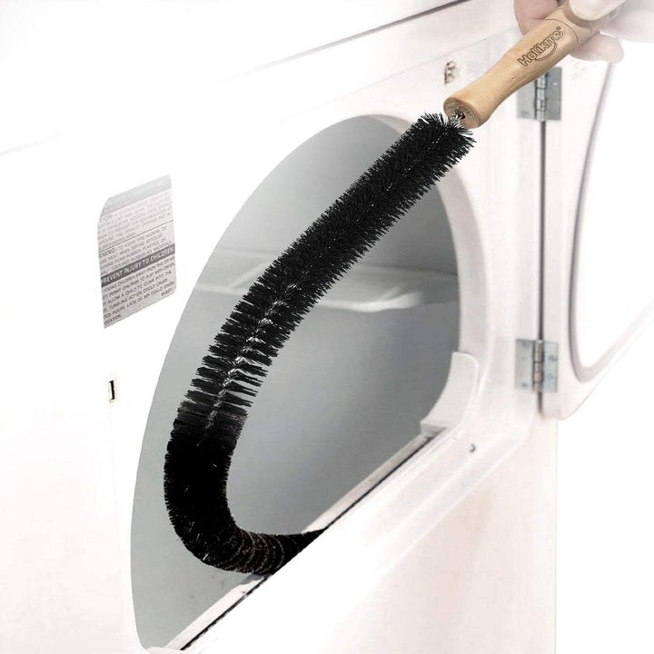 long thin brush wiping the inside of a dryer's lint trap