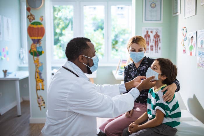 Young mom sitting with her son during a pediatrician appointment