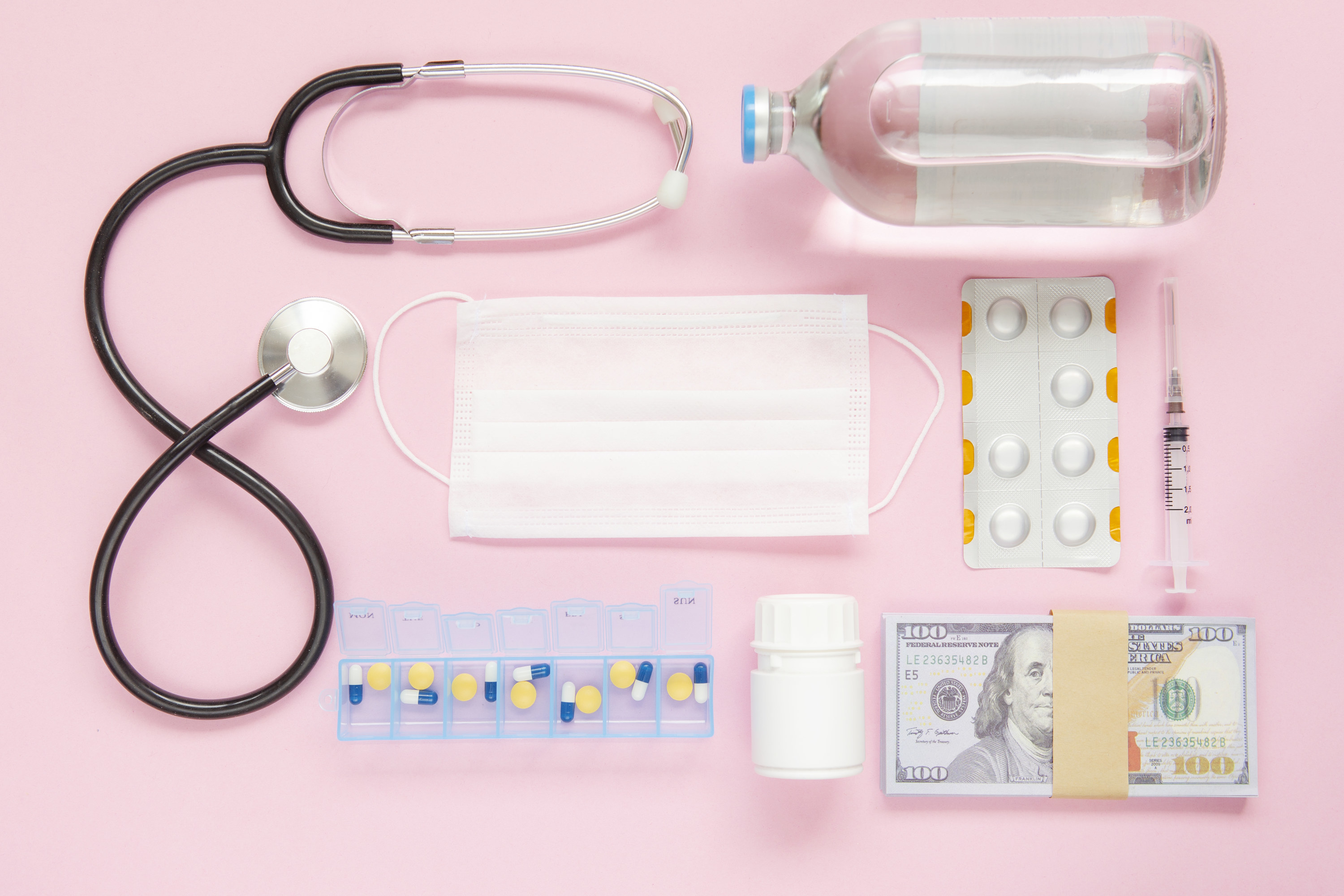 A stethoscope, medicine, face mask, and cash