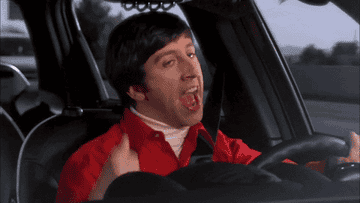 gif of someone driving in a car singing and dancing along to a song 